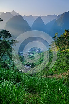 North Vietnamese valley with karst mountains covered by mist in the Ha Giang / Van region