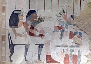 North wall fresco of Nakht and Tawy seated before the table of offerings in tomb TT52 in the Theban Necropolis near Luxor, Egypt.