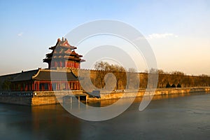 North-west tower in Forbidden City, Beijing. Winter scene captured in the glow of the setting sun.
