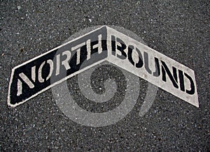 Northbound sign painted on a grey asphalt road