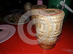 Northeastern-Thai cuisine have a stick rice basket is on the dining table.