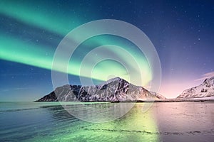 Northen light above mountains on the Lofoten islands.