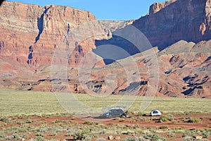 Northern Arizona desert with tent, car, and boats.