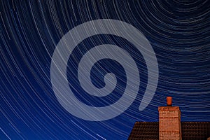 Northern hemisphere star trails with building chimney and following The Plough constellation during the Covid-19 pandemic with