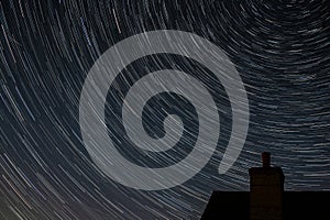 Northern hemisphere star trails with building chimney and following The Plough constellation during the Covid-19 pandemic with