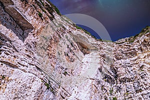 Northern lights above rocky hills near shore of Corfu island