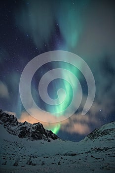 Northern lights, Aorora Borealis with starry over snow covered mountain peak at night