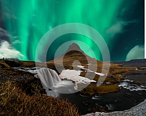 Northern lights aurora borealis appear over Mount Kirkjufell in Iceland.