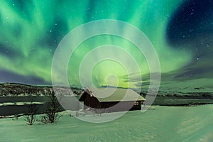 Northern lights Aurora Borealis in the night above a typically a