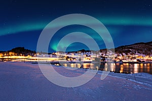 Scenic winter landscape with northern lights, Aurora borealis in night sky, Lofoten Islands, Norway