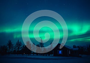 Northern lights Aurora Borealis over cottage in Lapland village. Finland