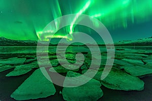 Northern lights (Aurora borealis) reflection across a lake in Iceland.