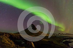 Northern lights or Aurora dancing with fully of stars on the sky of Iceland mountain landscape.