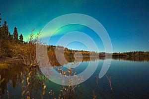 Northern lights and fall colors at calm lake