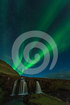 Northern lights in Iceland. Landscape full of kp5 Aurora Borealis. Amazing nightscape at Kirkjufell, scenic travel destination. Gr