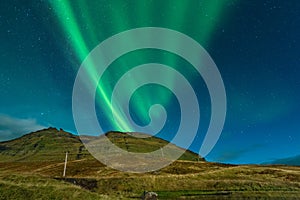 Northern lights in Iceland. Landscape full of kp5 Aurora Borealis. Amazing nightscape at Kirkjufell, scenic travel destination. Gr