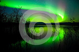 Northern lights mirrored on lake photo