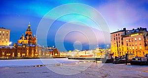 Northern lights over the frozen Old Port in Katajanokka district with Uspenski Orthodox Cathedral in Helsinki Finland