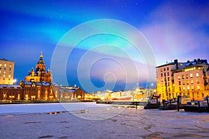 Northern lights over the frozen Old Port in Katajanokka district with Uspenski Orthodox Cathedral in Helsinki Finland