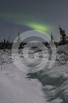 Northern lights over moonlight landscape