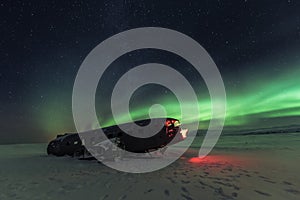 Northern lights over plane wreck on the wreck beach in Vik, Iceland