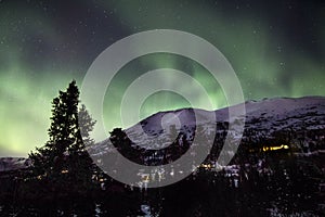 Northern Lights Over Snowy Alaskan Mountain