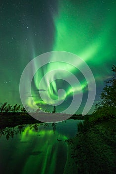 Northern lights with reflections in river