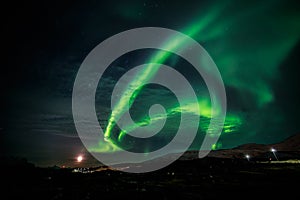 Northern lights and the rising Moon nearby nuuk city