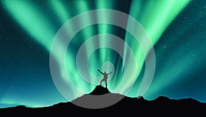 Northern lights and silhouette of standing happy man. Aurora