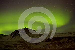 Northern lights with snowy mountains in the foreground