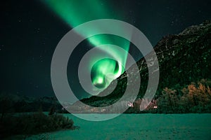 Northern Lights Swirl Above Mountain