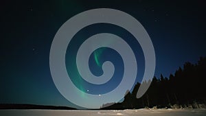 Northern Lights Time lapse 4K video, polar light or Aurora Borealis in the dark winter night sky over the arctic landscape.