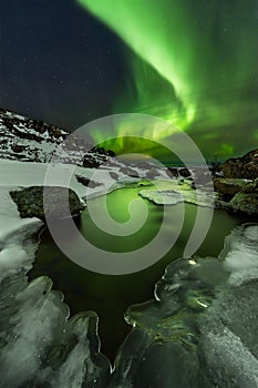 Northern lights under the Barents sea. Polar landscape at the winter night.