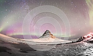 The Northern Lights and winter milky way over Kirkjufell
