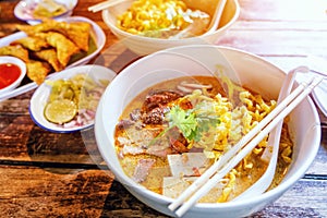 Northern Thai  Curried noodle soup Khao soi with chicken meat and spicy coconut milk