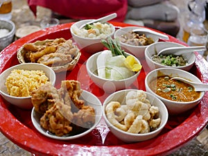 Northern Thai customary style dinner khantok with a variety of local menus photo