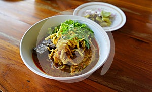 Northern Thai Noodle Curry Soup in bowl serve with lemon , onion