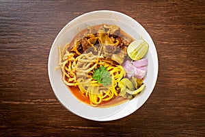 Northern Thai noodle curry soup with braised pork