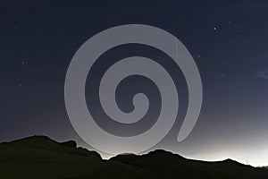 Northumberland night sky over Northumberlandia with stars, cloud and light pollution