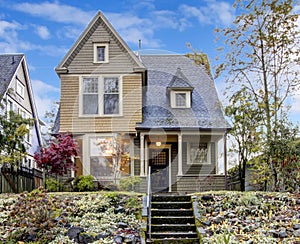 Northwest home with front porch and autumn landscape