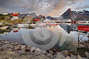 Norway coast with boat and red huts, Reine