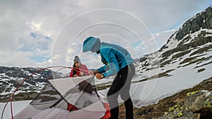 Norway - A couple putting up the tent in the wilderness