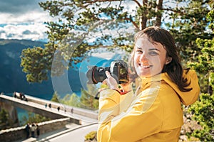 Norway. Happy Young Caucasian Woman Lady Tourist Traveler Photographer Taking Pictures Photos Near Stegastein Viewpoint