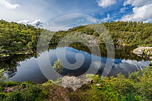 Norway Landscape. Close To Preikestolen Sightseeing Place. Mountain, Blue Sky. Reflection on Mountain Lake. photo