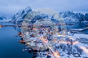 Norway Lofoten Reine aerial landscape in winter time with rainbow and mountains covered in snow