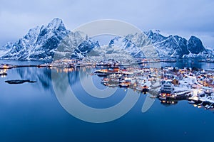 Norway Lofoten Reine aerial landscape in winter time with rainbow and mountains covered in snow