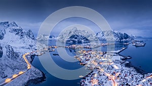 Norway Lofoten Reine aerial panoramic  landscape in winter time with rainbow and mountains covered in snow