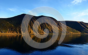 Reflection of mountains on the water in the fjords in Norway