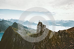 Norway mountaineering travel man standing on cliff mountain top