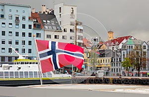 Norway national flag waving in norwegian city Bergen, Scandinavia, scandinavian Europe nordic town travel european cityscape fjord